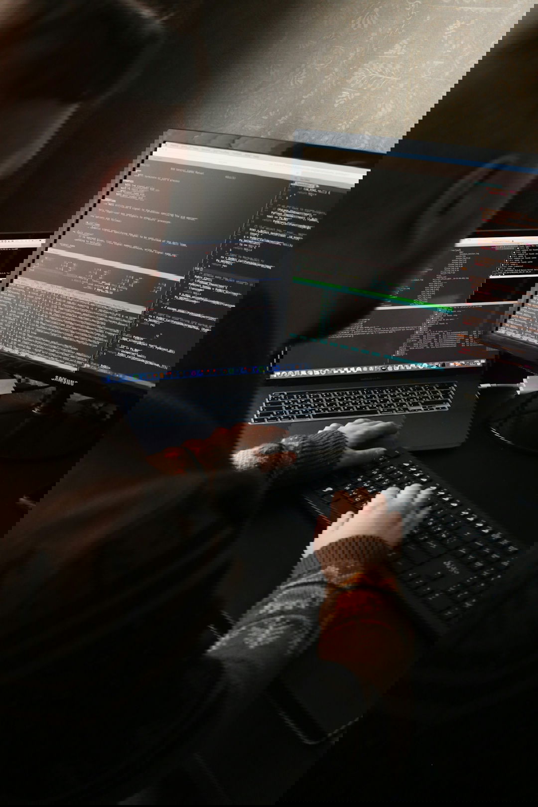 a man sitting in front of a computer on a desk